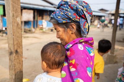 A woman in a displacement camp in Kachin State, Myanmar, holds a young child. 