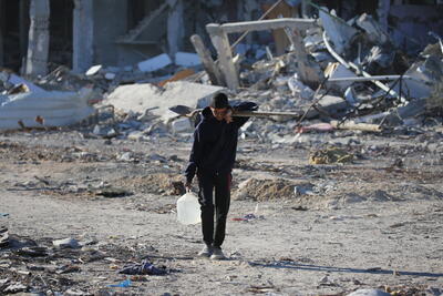 A Palestinian youth walks through the rubble of destroyed homes in Rafah, southern Gaza Strip.